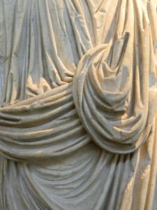 Intricate carving on marble depicting cloth on the sculpture